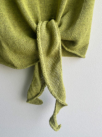 Close-up of Elio's asymmetric hem ties, knotted