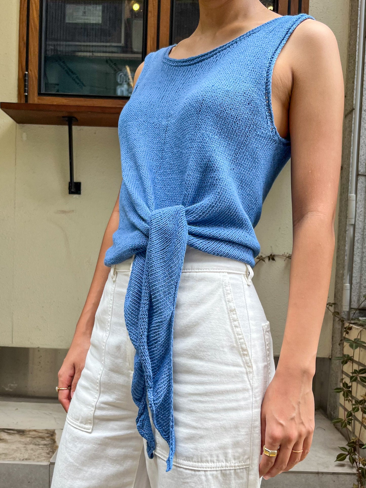 Elio Knot Tank Top in blue, side view with the hem ties hanging