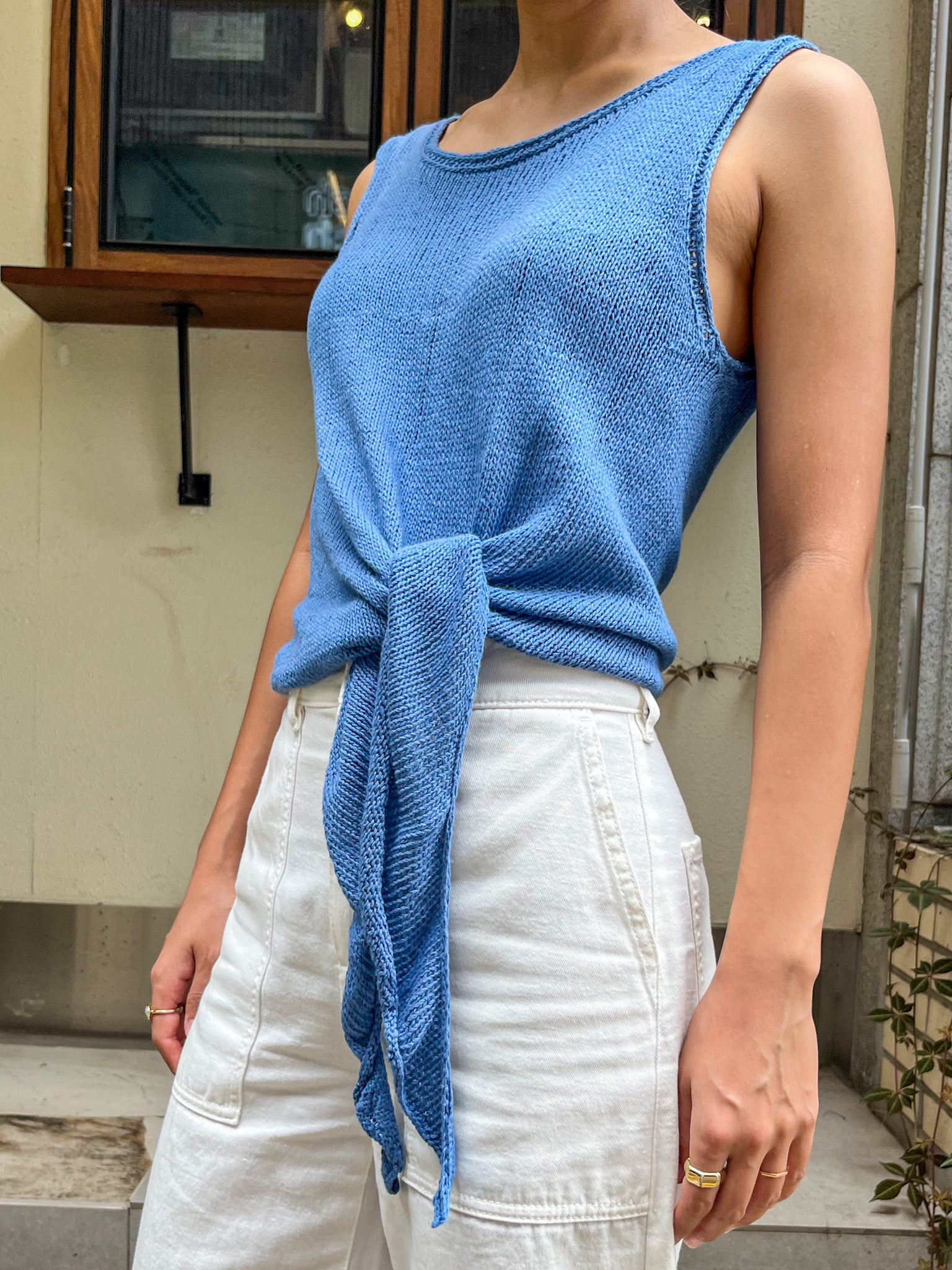 Elio Knot Tank Top in blue, side view with the hem ties hanging