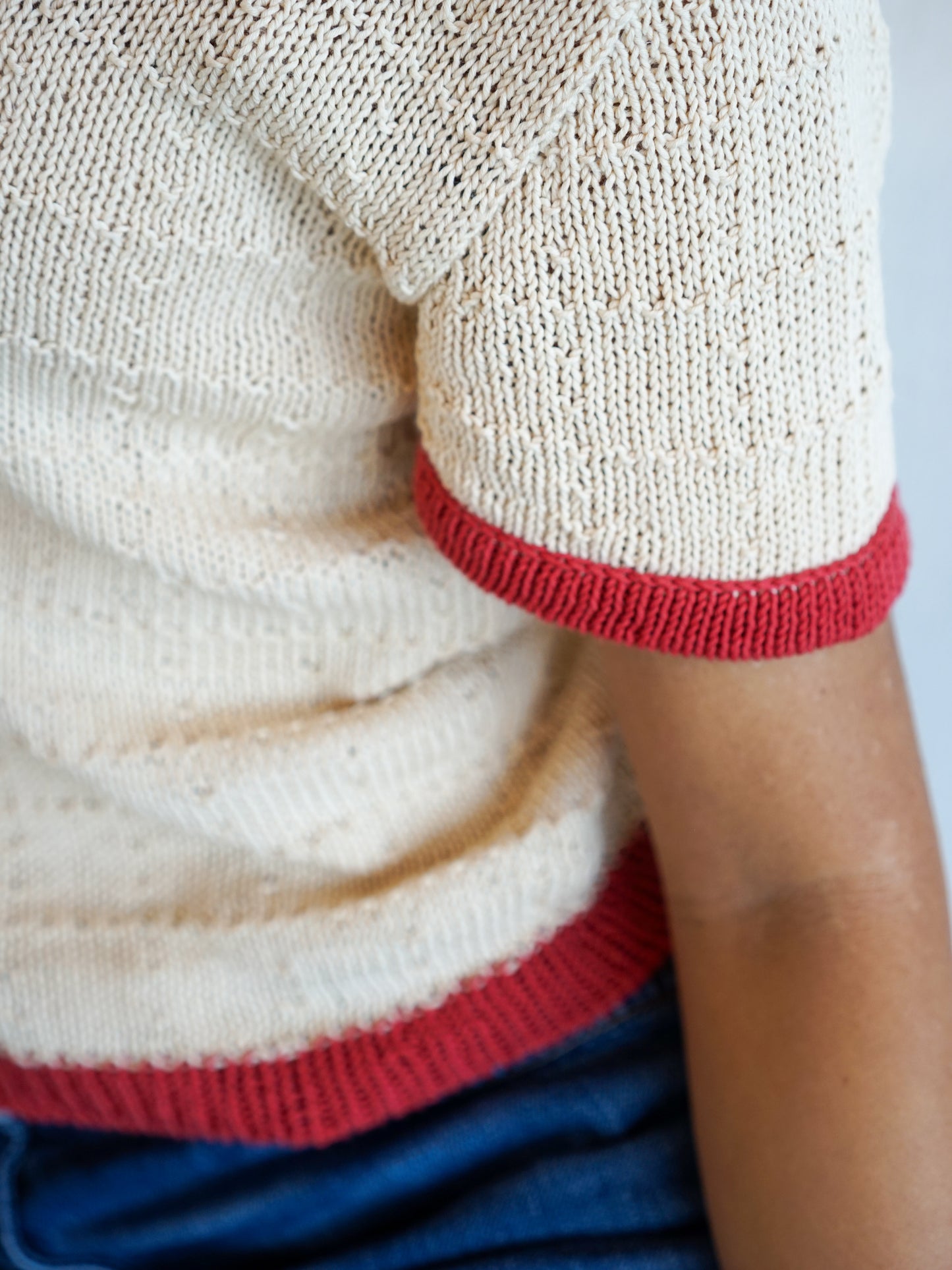 Contrast trim at the sleeve and hem, close up