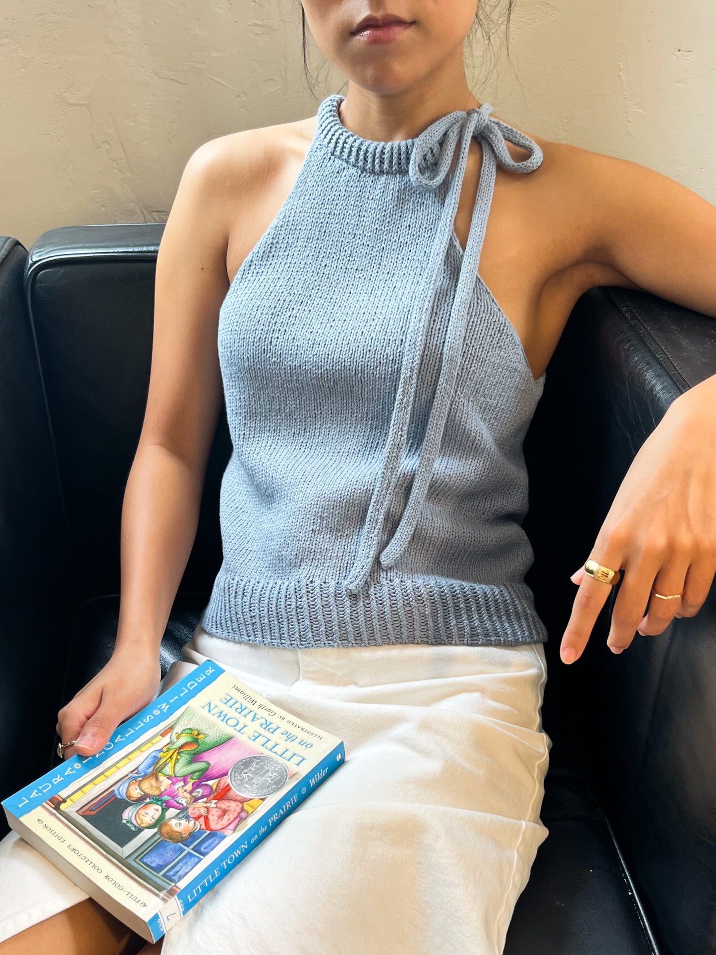 Odette Bow Halter Top worn in light blue, front view, seated